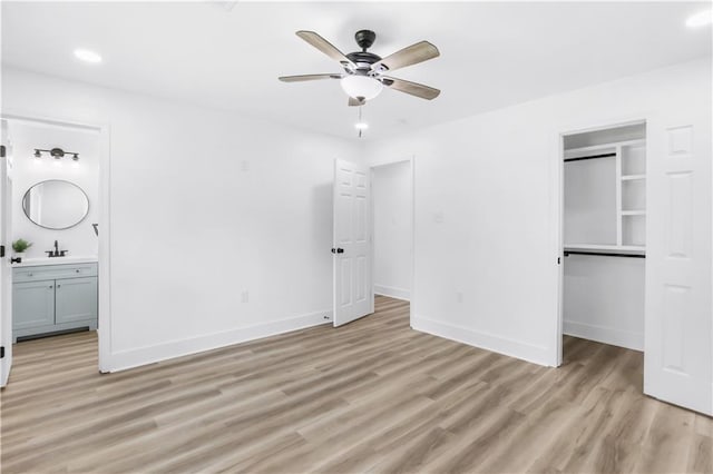 540 Ruth Dr, Westwego, LA 70094 - unfurnished bedroom featuring light wood-style flooring, ensuite bath, a walk in closet, a closet, and recessed lighting