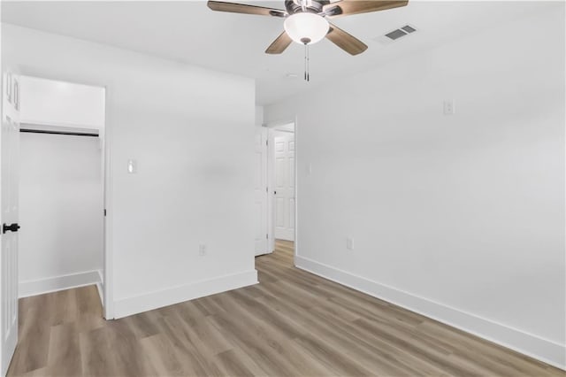 540 Ruth Dr, Westwego, LA 70094 - unfurnished bedroom featuring light wood-style flooring, a closet, a walk in closet, and ceiling fan