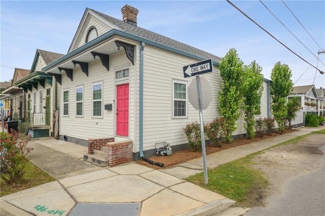 1131 N Roman St, New Orleans, LA 70116 - view of front of home featuring a chimney