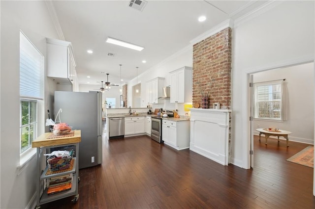 1131 N Roman St, New Orleans, LA 70116 - kitchen with stainless steel appliances, a ceiling fan, ornamental molding, white cabinetry, and dark wood finished floors
