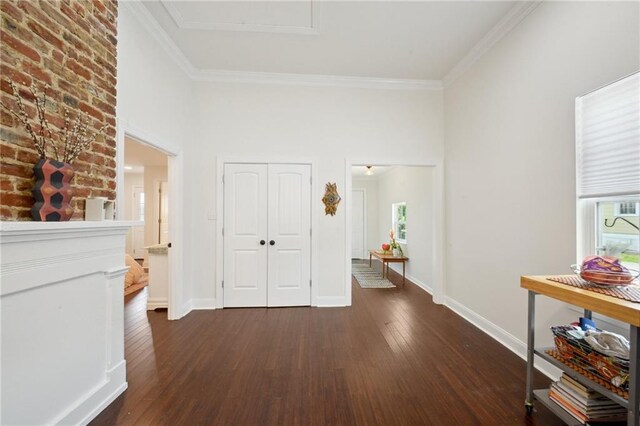 1131 N Roman St, New Orleans, LA 70116 - hallway featuring dark wood finished floors, ornamental molding, a towering ceiling, and attic access