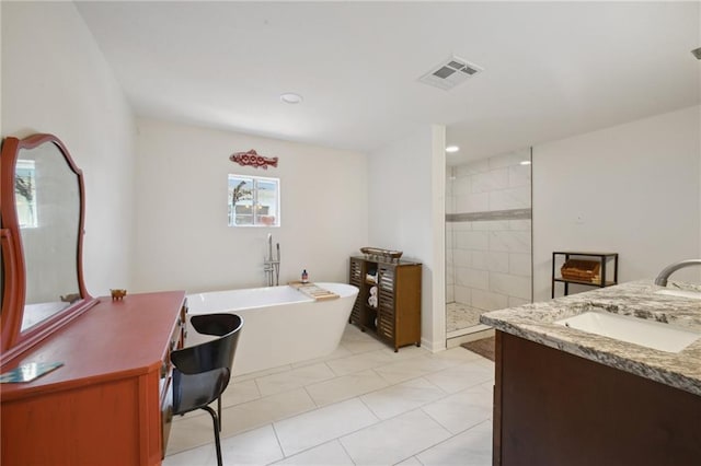 1131 N Roman St, New Orleans, LA 70116 - full bath featuring a freestanding bath, double vanity, tiled shower, tile patterned flooring, and recessed lighting