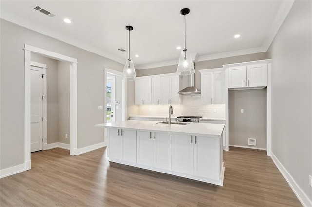 72701 Robindale Dr, Covington, LA 70435 - kitchen featuring white cabinets, decorative backsplash, light countertops, light wood-style floors, and recessed lighting