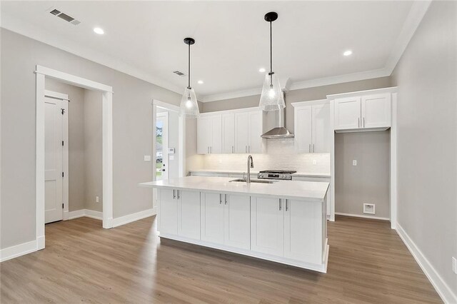 72701 Robindale Dr, Covington, LA 70435 - kitchen featuring white cabinets, decorative backsplash, light countertops, light wood-style floors, and recessed lighting
