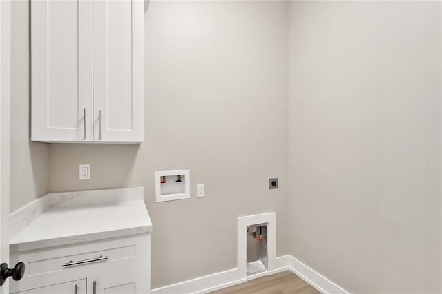 72701 Robindale Dr, Covington, LA 70435 - washroom featuring cabinet space, washer hookup, electric dryer hookup, and light wood-style floors
