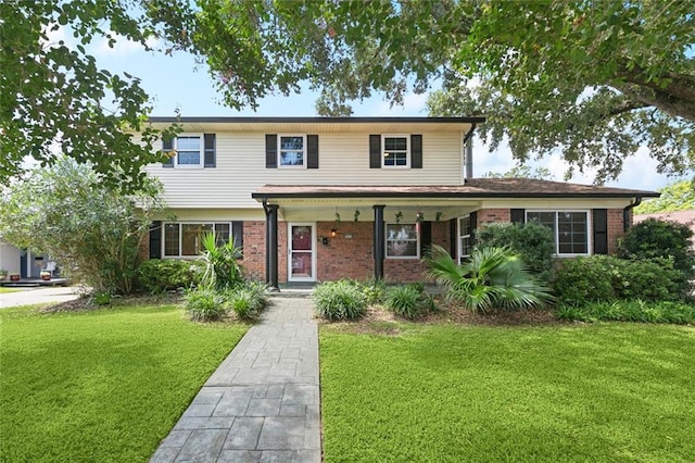 7032 Glenn St, Metairie, LA 70003 - traditional-style home with covered porch, a front yard, and brick siding