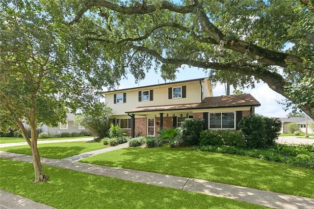 7032 Glenn St, Metairie, LA 70003 - traditional-style home with a front yard and brick siding