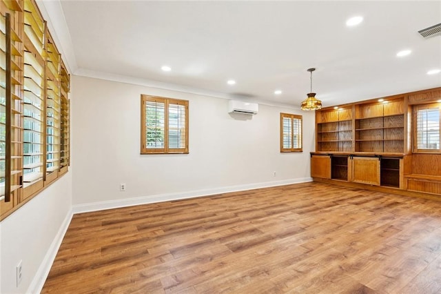 7032 Glenn St, Metairie, LA 70003 - unfurnished living room with recessed lighting, healthy amount of natural light, light wood finished floors, a wall mounted AC, and crown molding