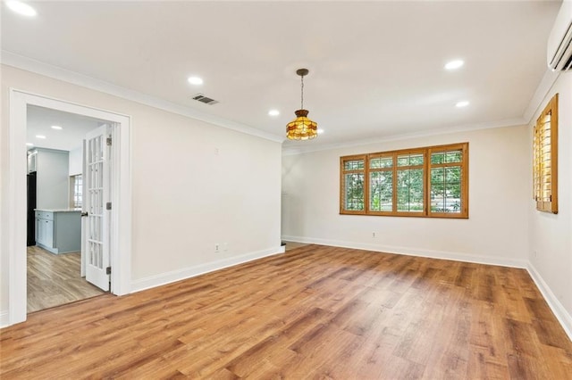 7032 Glenn St, Metairie, LA 70003 - empty room featuring light wood-style floors, recessed lighting, crown molding, and a wall mounted AC