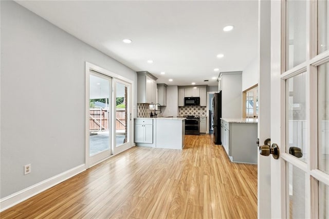 7032 Glenn St, Metairie, LA 70003 - kitchen with black appliances, gray cabinets, light wood-style flooring, backsplash, and recessed lighting