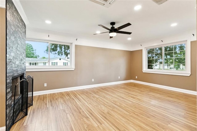 7032 Glenn St, Metairie, LA 70003 - unfurnished living room with a ceiling fan, light wood-type flooring, recessed lighting, and a stone fireplace