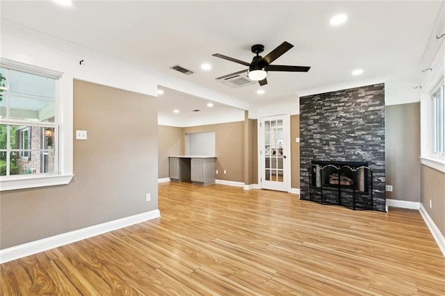 7032 Glenn St, Metairie, LA 70003 - unfurnished living room with ceiling fan, light wood-style flooring, a tiled fireplace, and recessed lighting