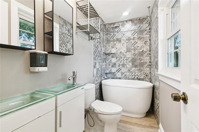 7032 Glenn St, Metairie, LA 70003 - bathroom featuring double vanity, wood finished floors, and a freestanding tub