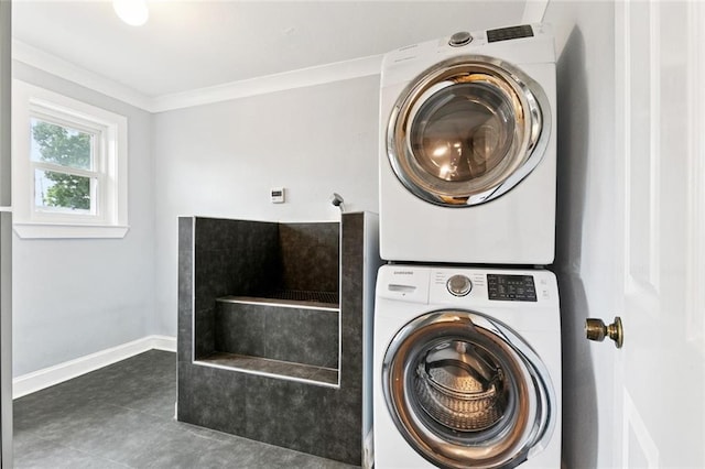 7032 Glenn St, Metairie, LA 70003 - laundry room with stacked washer and clothes dryer, ornamental molding, and tile patterned floors