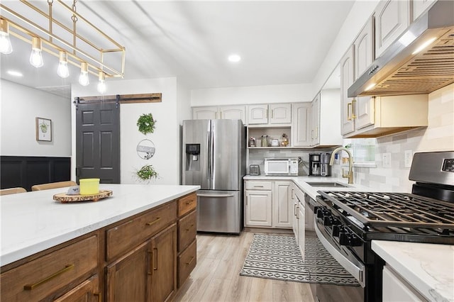 713 N Lester Ave, Metairie, LA 70003 - kitchen featuring exhaust hood, appliances with stainless steel finishes, a barn door, open shelves, and tasteful backsplash