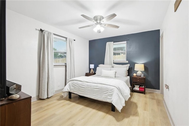 713 N Lester Ave, Metairie, LA 70003 - bedroom with wood finished floors, multiple windows, and a ceiling fan