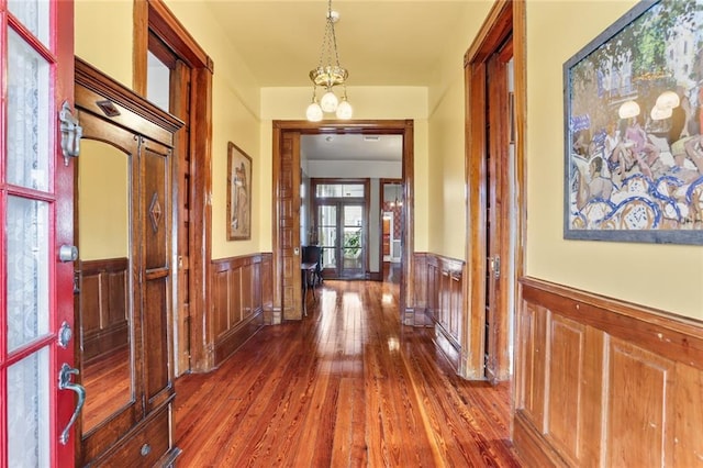 202 S Pierce St, New Orleans, LA 70119 - hallway with a wainscoted wall, hardwood / wood-style flooring, and a chandelier