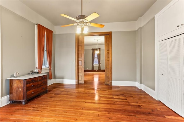 202 S Pierce St, New Orleans, LA 70119 - bedroom with light wood-style flooring, a closet, multiple windows, and ceiling fan
