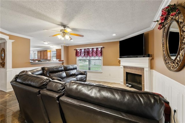 1111 Artesa Dr, Marrero, LA 70072 - living area with a wainscoted wall, ornamental molding, a textured ceiling, ceiling fan, and a decorative wall