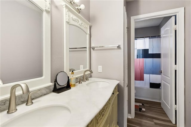 1111 Artesa Dr, Marrero, LA 70072 - full bath with double vanity, wood finished floors, and shower / tub combo
