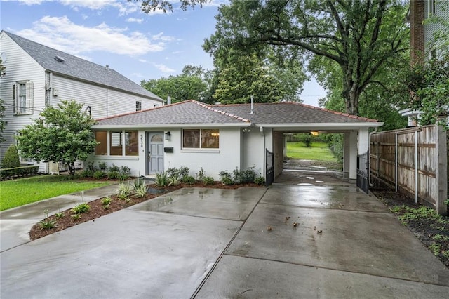 5538 Bellaire Dr, New Orleans, LA 70124 - view of front of house with concrete driveway and a carport