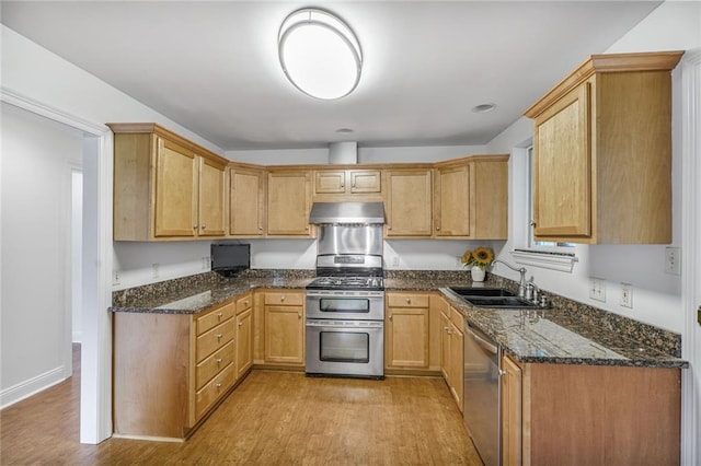 5538 Bellaire Dr, New Orleans, LA 70124 - kitchen featuring appliances with stainless steel finishes, ventilation hood, light wood-type flooring, and dark stone countertops