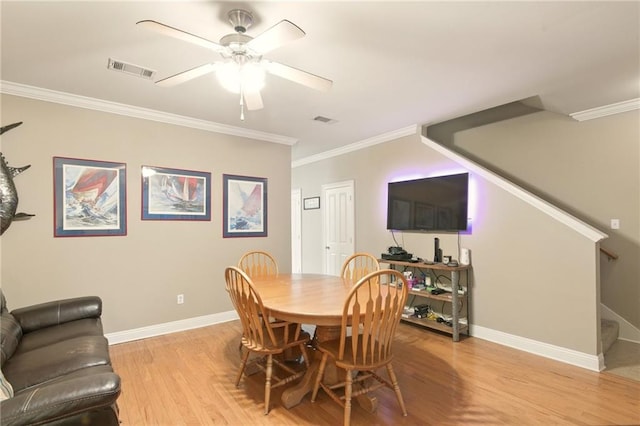 5191 Arlington Ct, Baton Rouge, LA 70820 - dining room with stairway, light wood finished floors, crown molding, and ceiling fan