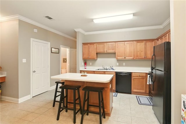 5191 Arlington Ct, Baton Rouge, LA 70820 - kitchen with black appliances, light tile patterned floors, ornamental molding, light countertops, and a kitchen island
