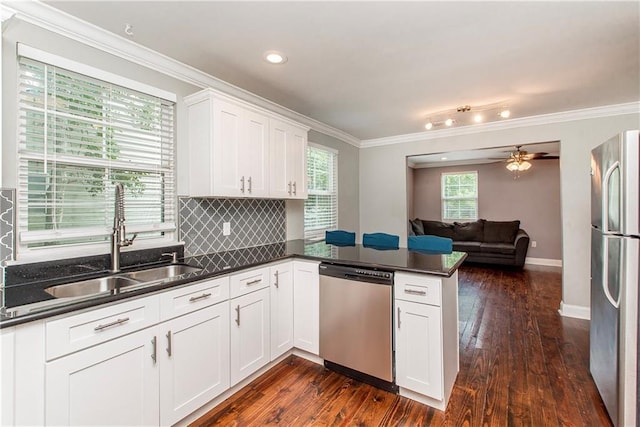 4108 Rayne Dr, New Orleans, LA 70122 - kitchen with dishwasher, freestanding refrigerator, open floor plan, a peninsula, and dark wood-style floors