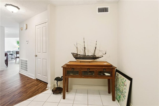 105 Mariners Is Unit 105, Mandeville, LA 70448 - hall with light wood-style floors and baseboards