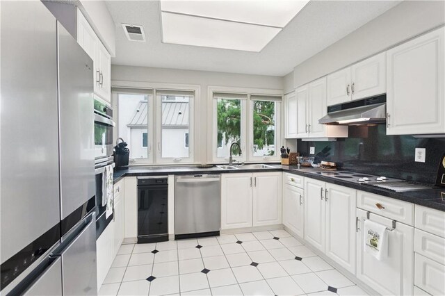 105 Mariners Is Unit 105, Mandeville, LA 70448 - bedroom with light colored carpet, a ceiling fan, a textured ceiling, and ensuite bath