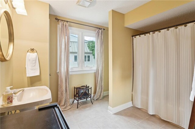 105 Mariners Is Unit 105, Mandeville, LA 70448 - full bathroom with a garden tub, vanity, and tile patterned floors