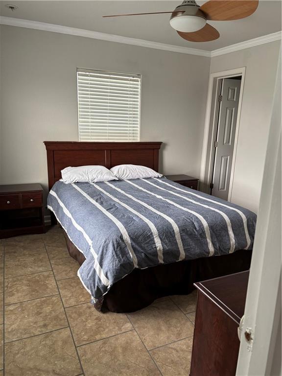 24092 Chef Menteur Hwy, New Orleans, LA 70129 - tiled bedroom with ornamental molding and a ceiling fan