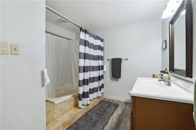 233 Penfold Pl, Harahan, LA 70123 - bathroom with vanity, curtained shower, and wood finished floors