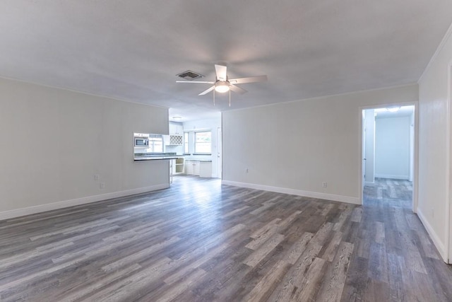 1729 High Ave, Metairie, LA 70001 - unfurnished living room featuring a ceiling fan and dark wood-type flooring