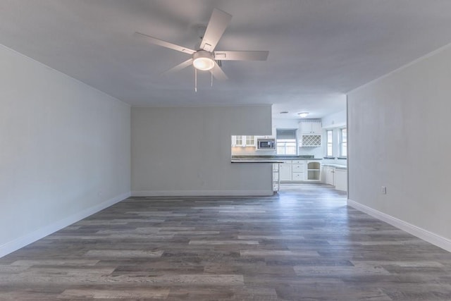 1729 High Ave, Metairie, LA 70001 - unfurnished living room with a ceiling fan and dark wood-style flooring