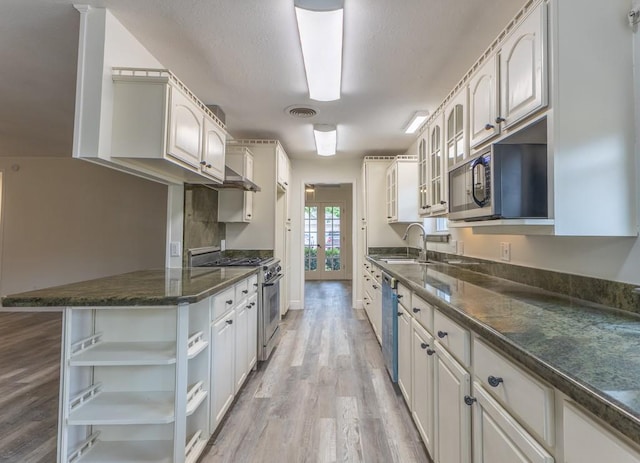 1729 High Ave, Metairie, LA 70001 - kitchen featuring appliances with stainless steel finishes, open shelves, light wood-style floors, glass insert cabinets, and french doors