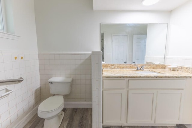 1729 High Ave, Metairie, LA 70001 - bathroom featuring tile walls, vanity, wood finished floors, and a wainscoted wall
