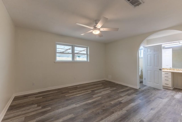 1729 High Ave, Metairie, LA 70001 - unfurnished bedroom with arched walkways, dark wood finished floors, and a ceiling fan