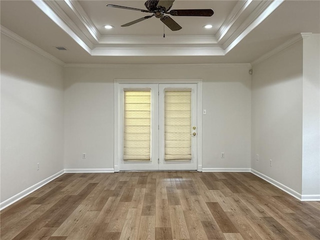 1904 Hall Ave, Metairie, LA 70003 - unfurnished room featuring a raised ceiling, a ceiling fan, ornamental molding, and wood finished floors