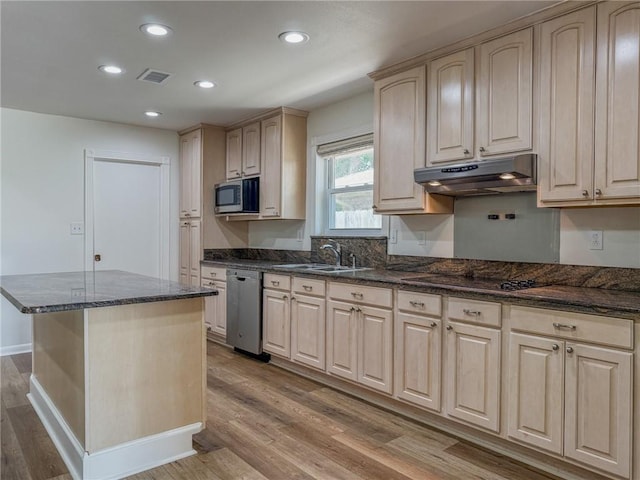 1904 Hall Ave, Metairie, LA 70003 - kitchen featuring under cabinet range hood, stainless steel appliances, wood finished floors, recessed lighting, and dark stone counters