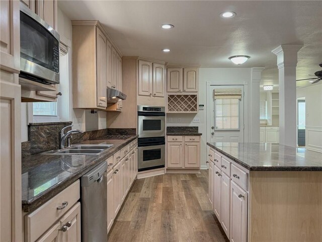 1904 Hall Ave, Metairie, LA 70003 - kitchen featuring stainless steel appliances, wood finished floors, under cabinet range hood, recessed lighting, and dark stone counters