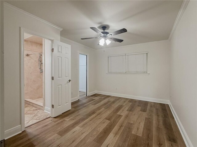 1904 Hall Ave, Metairie, LA 70003 - unfurnished bedroom featuring wood finished floors, crown molding, ceiling fan, and ensuite bathroom
