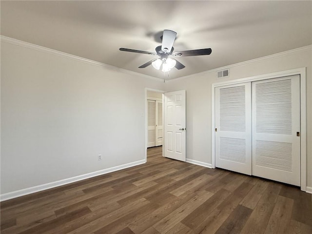 1904 Hall Ave, Metairie, LA 70003 - unfurnished bedroom with a closet, dark wood-style floors, ornamental molding, and ceiling fan