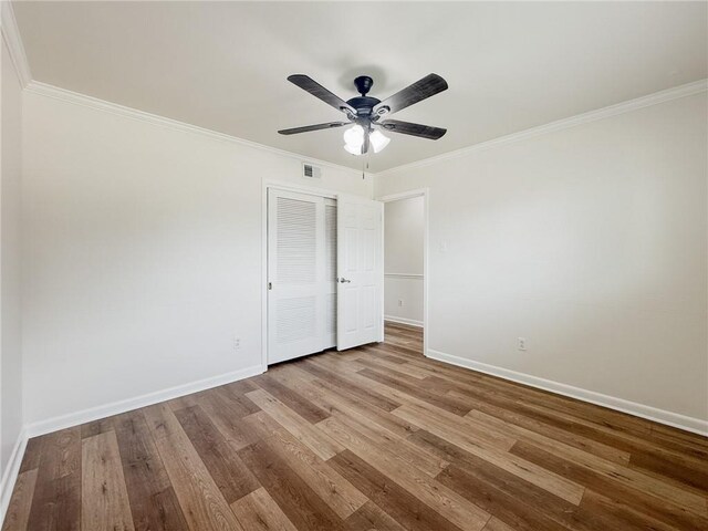 1904 Hall Ave, Metairie, LA 70003 - unfurnished bedroom featuring wood finished floors, crown molding, a closet, and ceiling fan