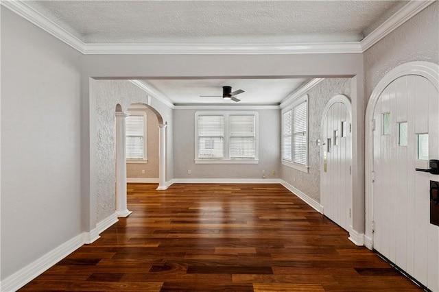 4752 Demontluzin St, New Orleans, LA 70122 - entrance foyer featuring arched walkways, wood finished floors, a ceiling fan, a textured ceiling, and crown molding