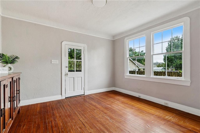 4752 Demontluzin St, New Orleans, LA 70122 - empty room with plenty of natural light, hardwood / wood-style floors, and ornamental molding