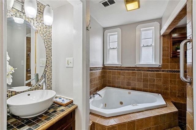 4752 Demontluzin St, New Orleans, LA 70122 - bathroom featuring a jetted tub and vanity