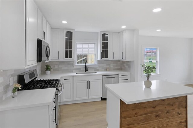 1909 Maryland Ave, Kenner, LA 70062 - kitchen with appliances with stainless steel finishes, white cabinets, healthy amount of natural light, and recessed lighting