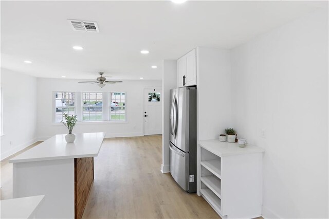 1909 Maryland Ave, Kenner, LA 70062 - kitchen featuring freestanding refrigerator, light wood-type flooring, white cabinets, light countertops, and a ceiling fan